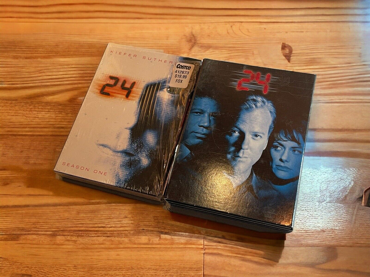24 Kiefer Sutherland DVD collection with Season One and additional seasons boxed sets on wooden surface