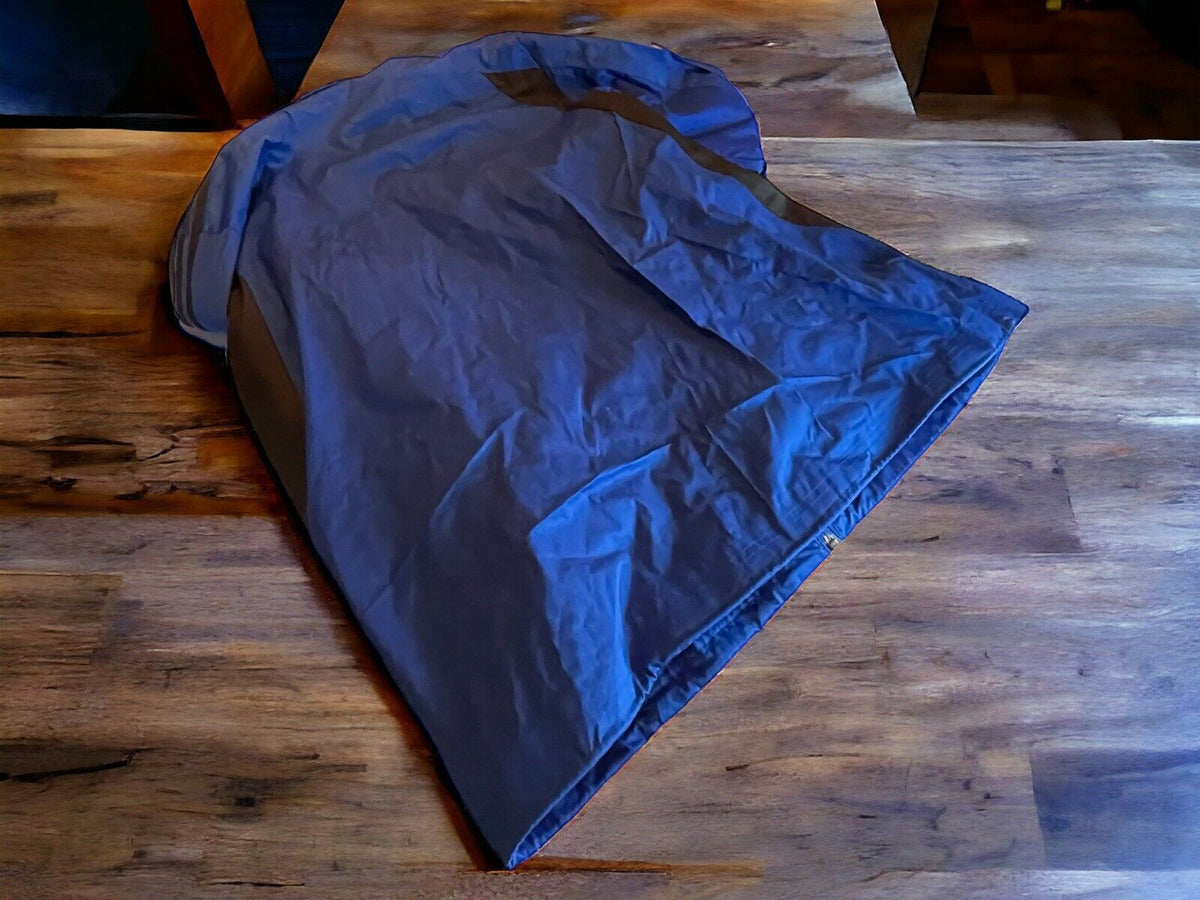 Large Adidas track jacket in dark color laid flat on wooden surface