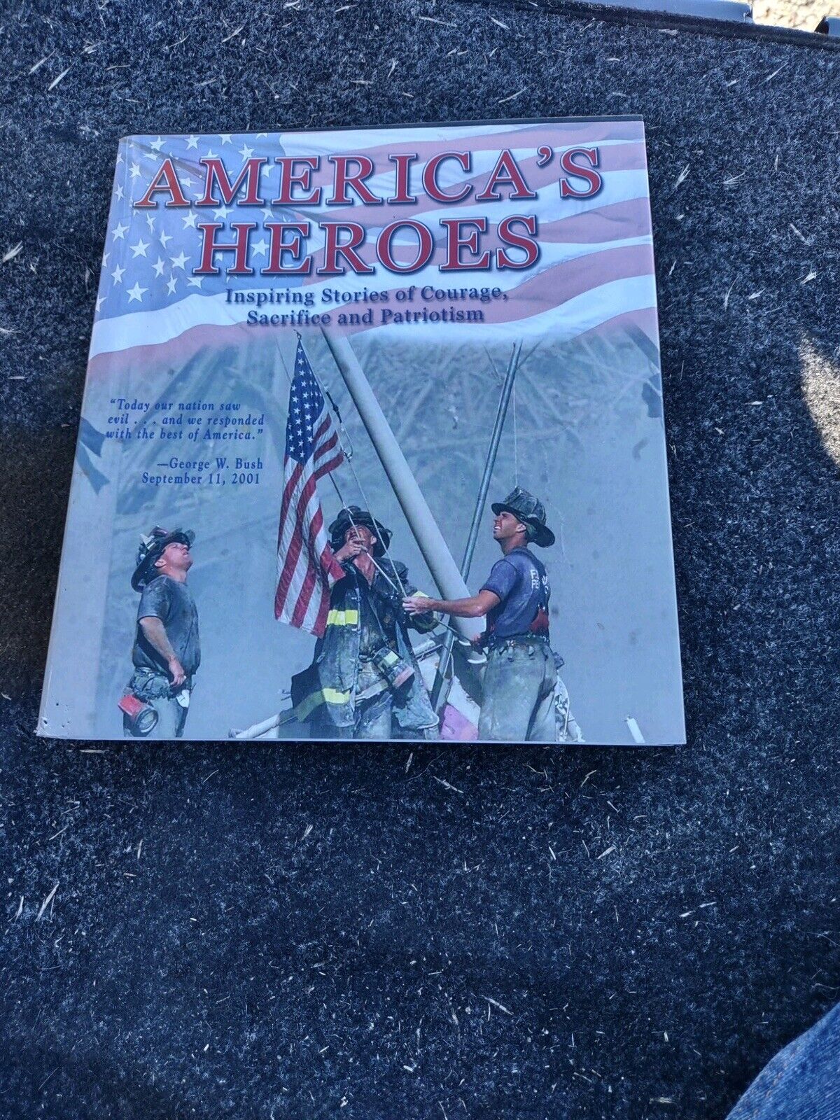 America's Heroes book with cover showing firefighters raising flag and tribute to courage and patriotism