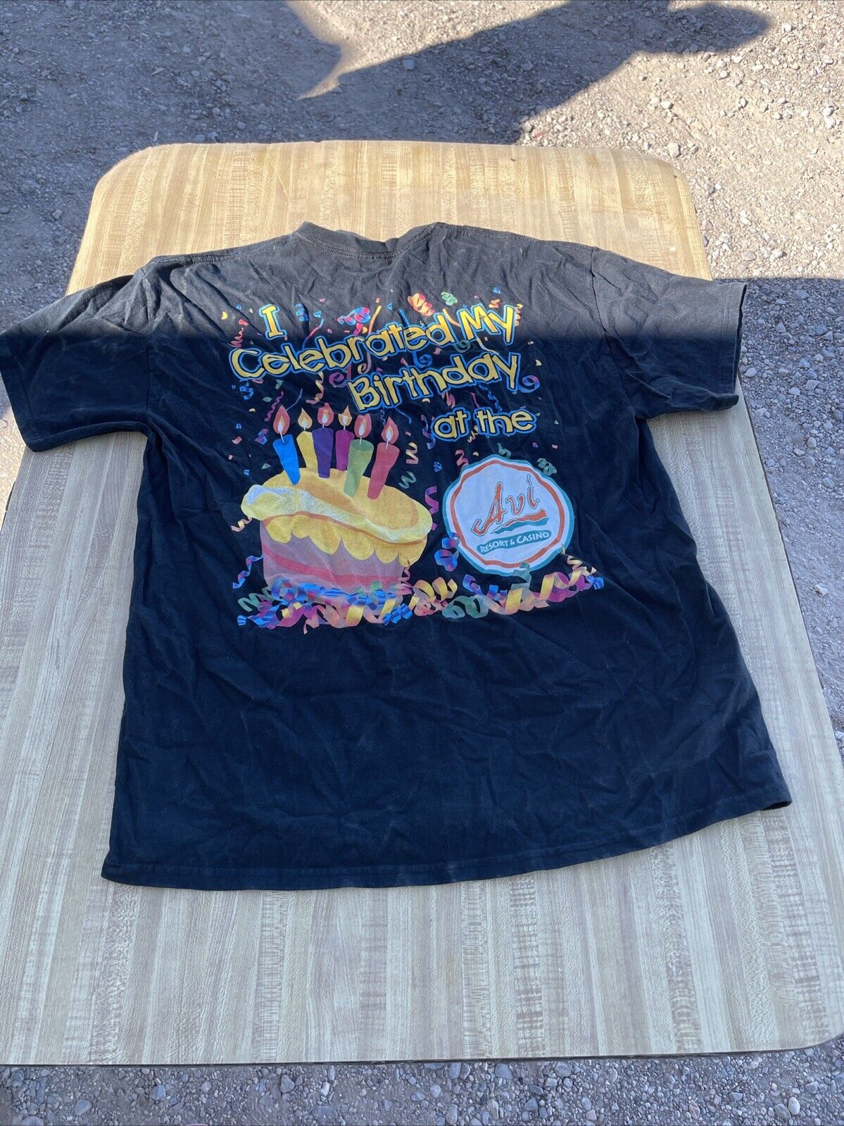 Avi Casino t shirt XL in black featuring colorful birthday cake and celebration design on the back