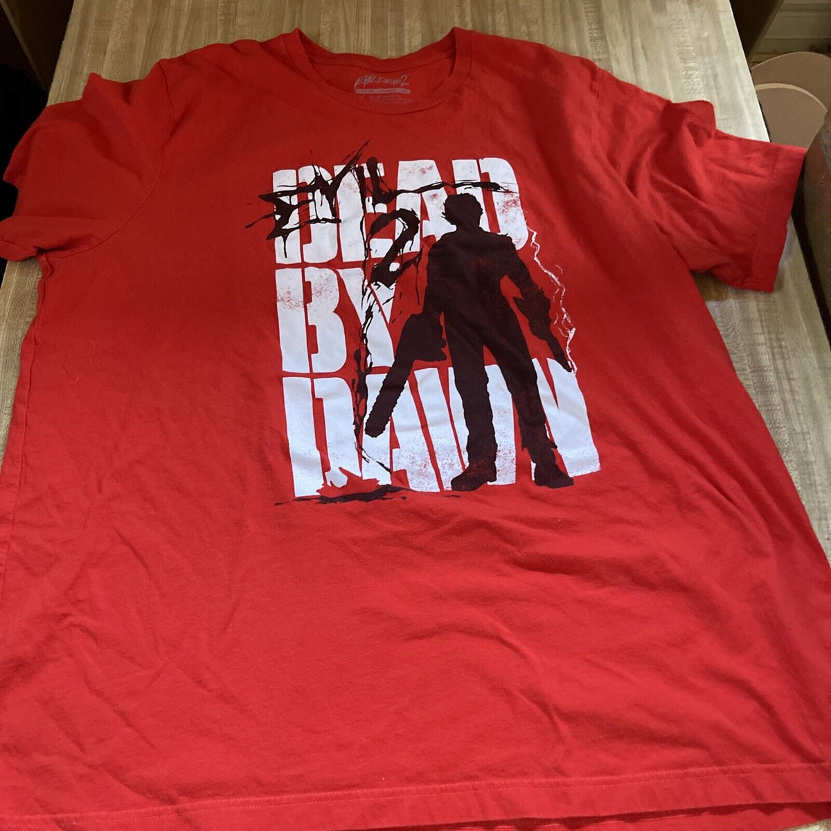 Red Dead By Dawn graphic T-shirt featuring silhouettes for Evil Dead apparel for men
