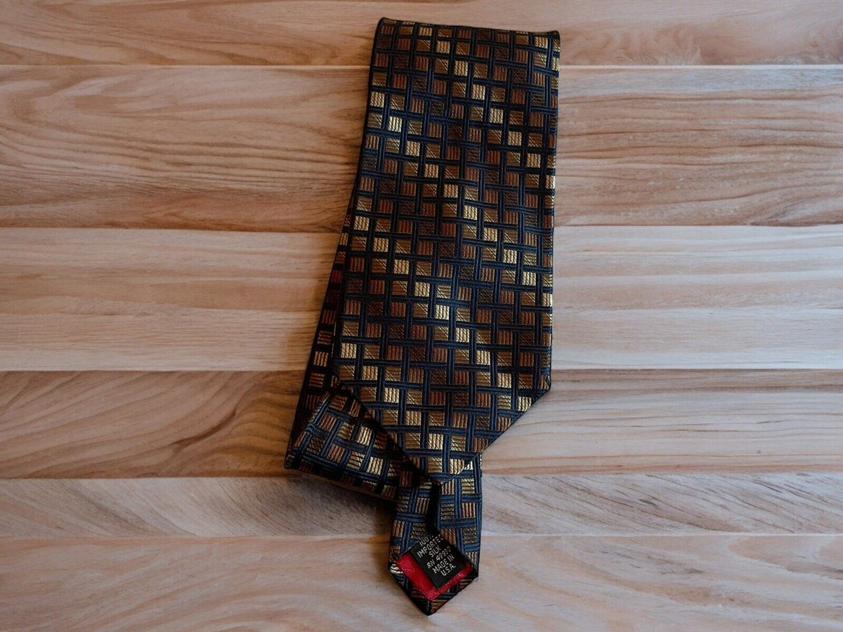 Luxury silk tie with gold and black checkered pattern neatly folded on a wooden surface