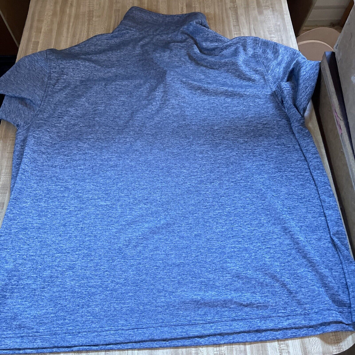 Men's 3XLT golf polo in heather blue laid flat showing back side from 1118 Emporium