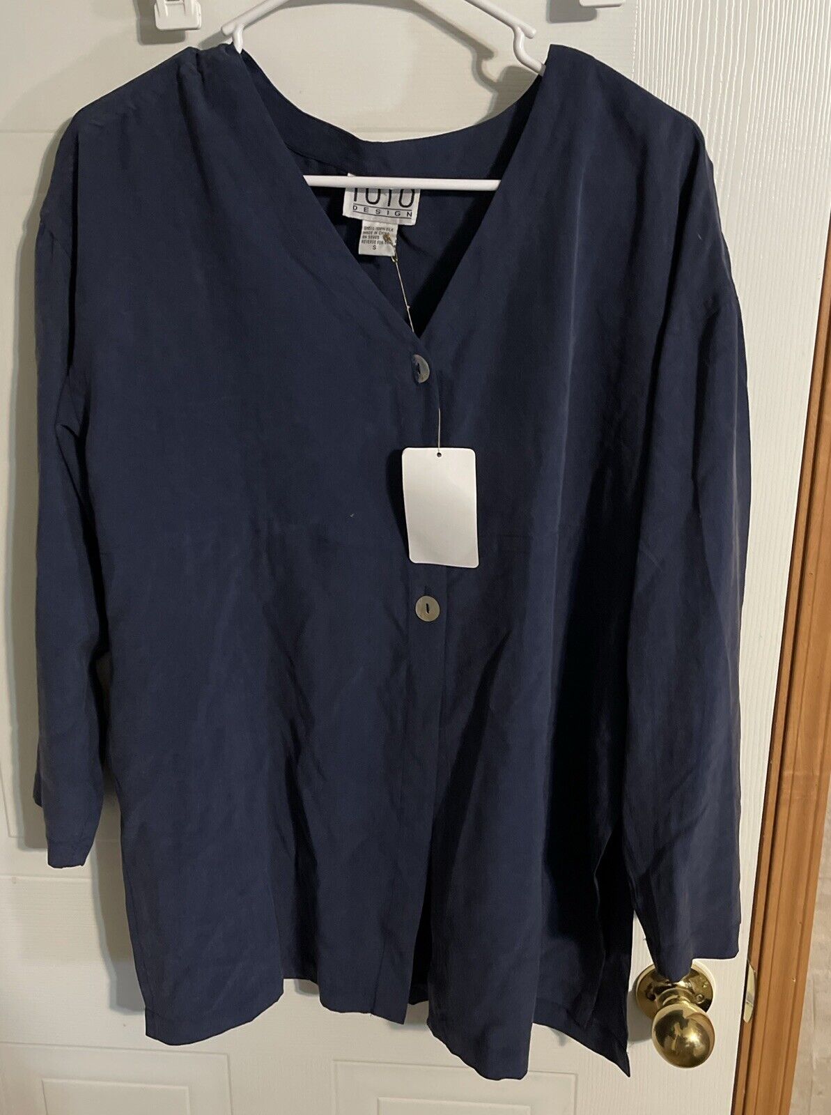 Navy blue 1010 Design silk loungewear top with buttons hanging on white hanger