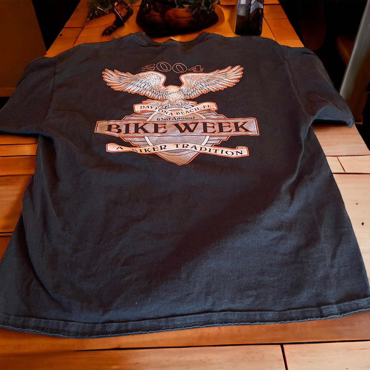 2004 Bike Week t shirt with eagle and biker tradition graphic printed on black fabric