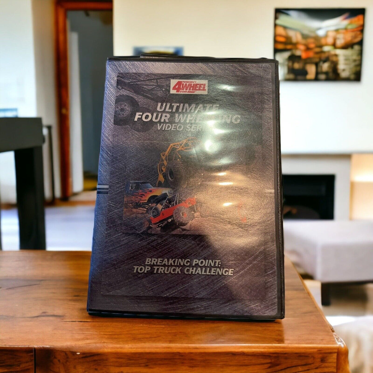 1118 Emporium monster truck dvd collection featuring Ultimate Four Wheeling video series on wooden table