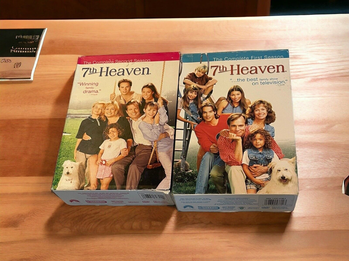 7th Heaven TV show DVDs complete first and second season box sets on wooden surface