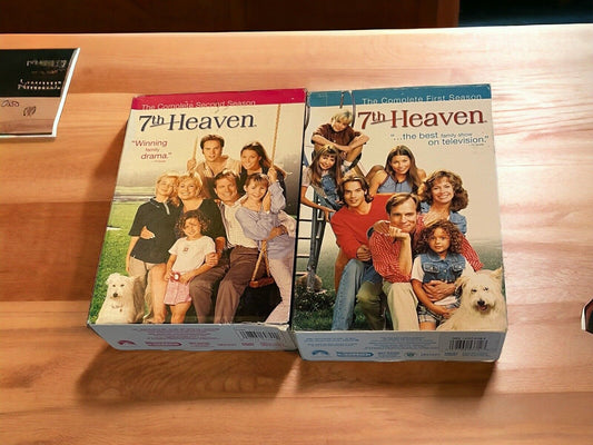 7th Heaven TV show DVDs complete first and second season box sets on wooden surface