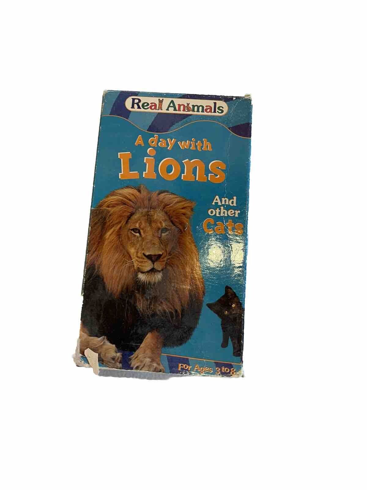 A Day With Lions VHS featuring a large lion and a small cat on blue cover by 1118 Emporium