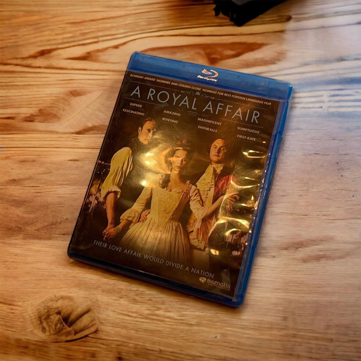 A Royal Affair Blu-ray disc case featuring historical drama cover with three characters on wooden table