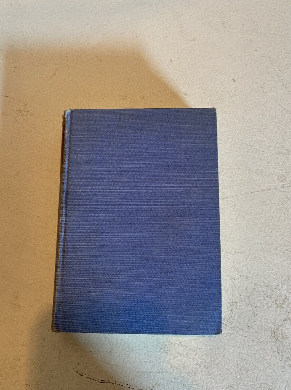 Blue cloth cover Action By Night hardcover book lying on a textured surface