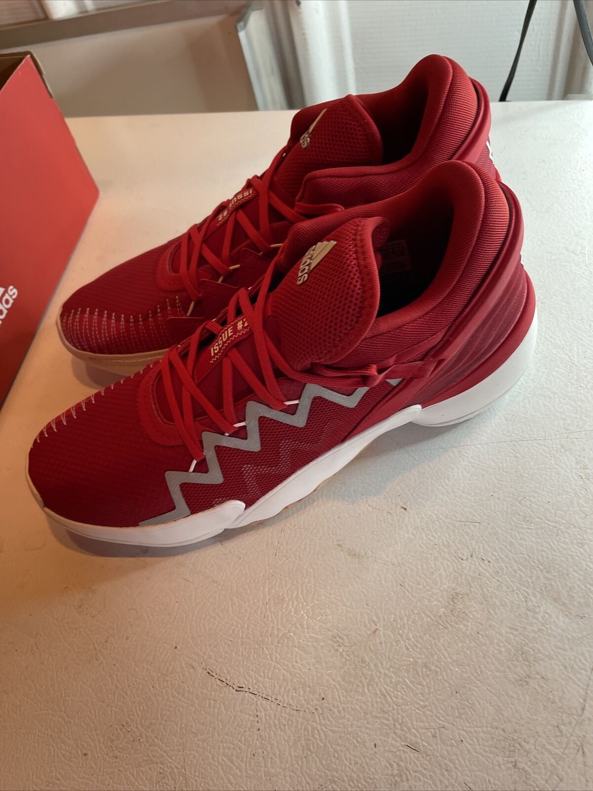 Men's red adidas basketball shoes with white sole and zigzag design from 1118 Emporium