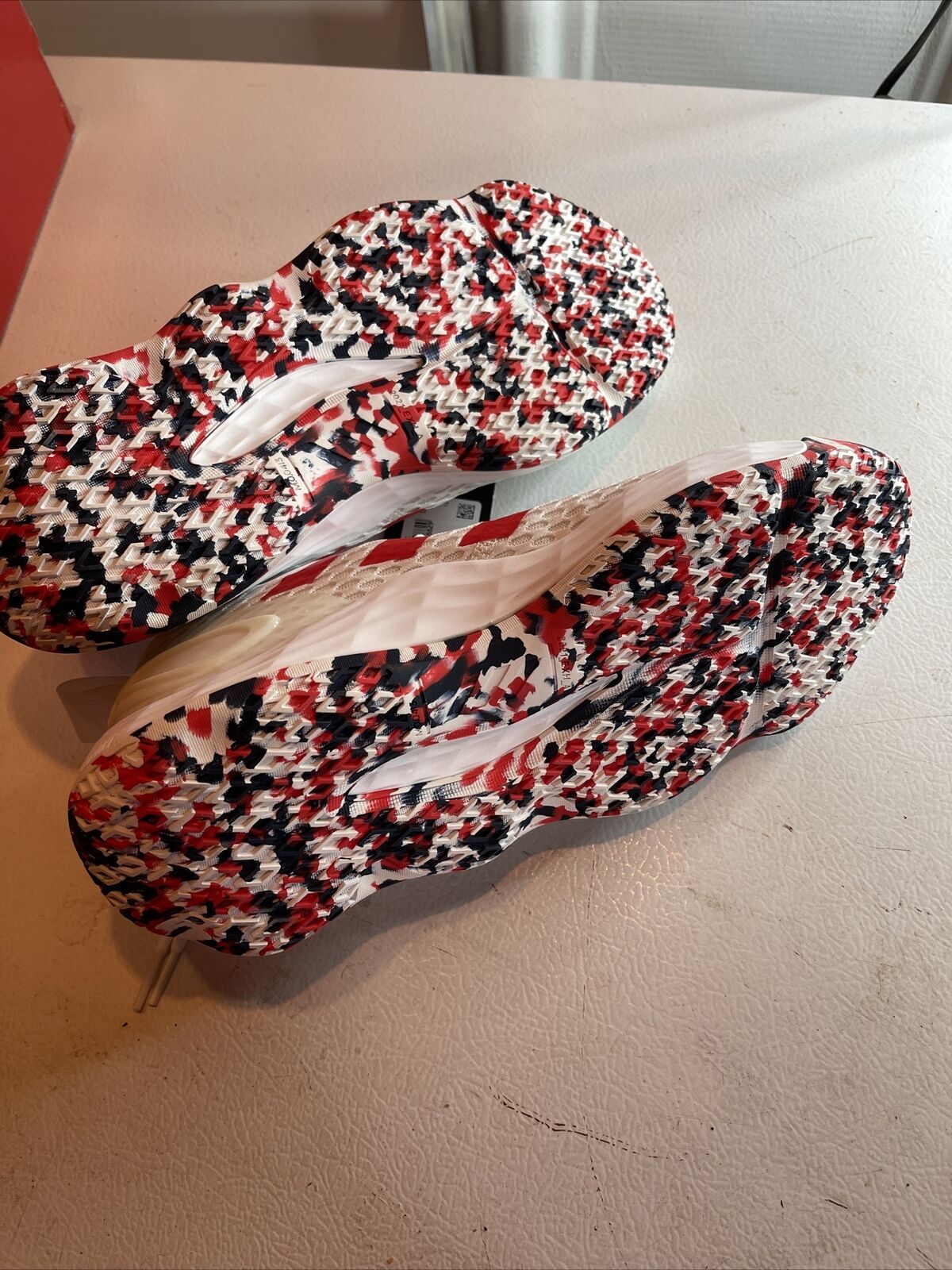 Adidas SM Exhibit A Team USA shoes with red black and white patterned sole on display