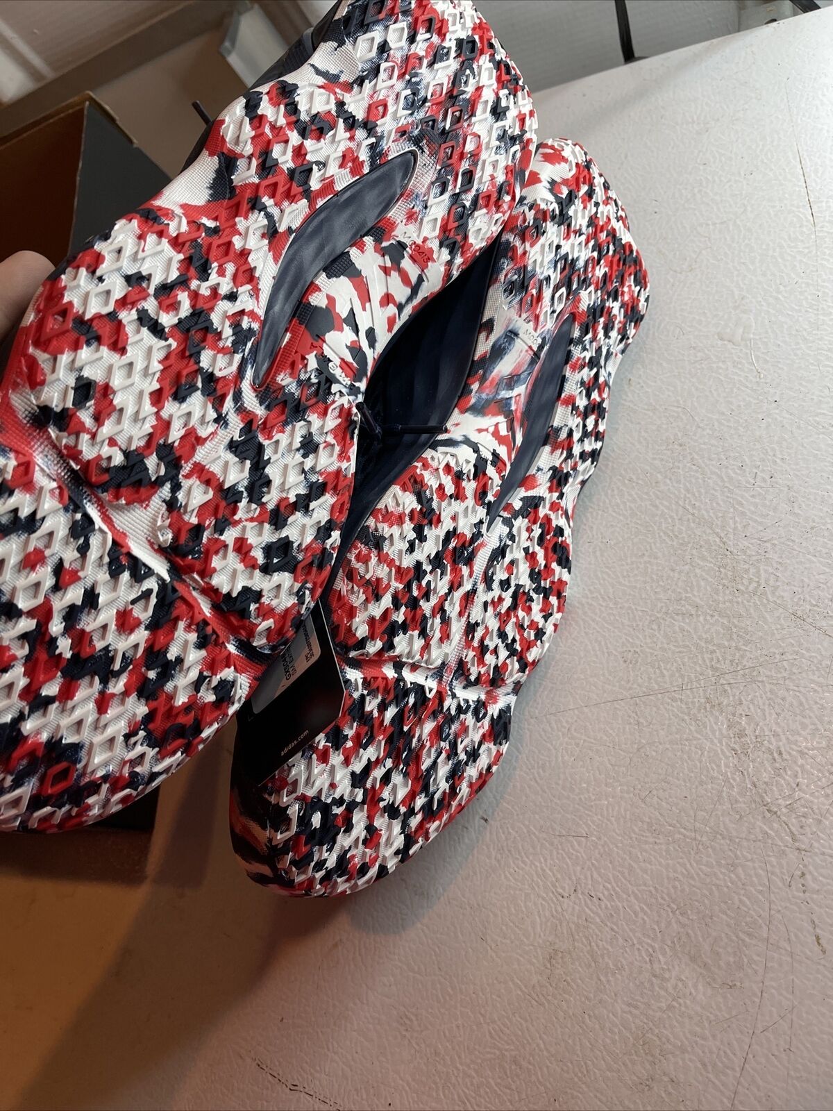 Close-up of Adidas SM Exhibit A Team USA shoes with red white and black patterned soles