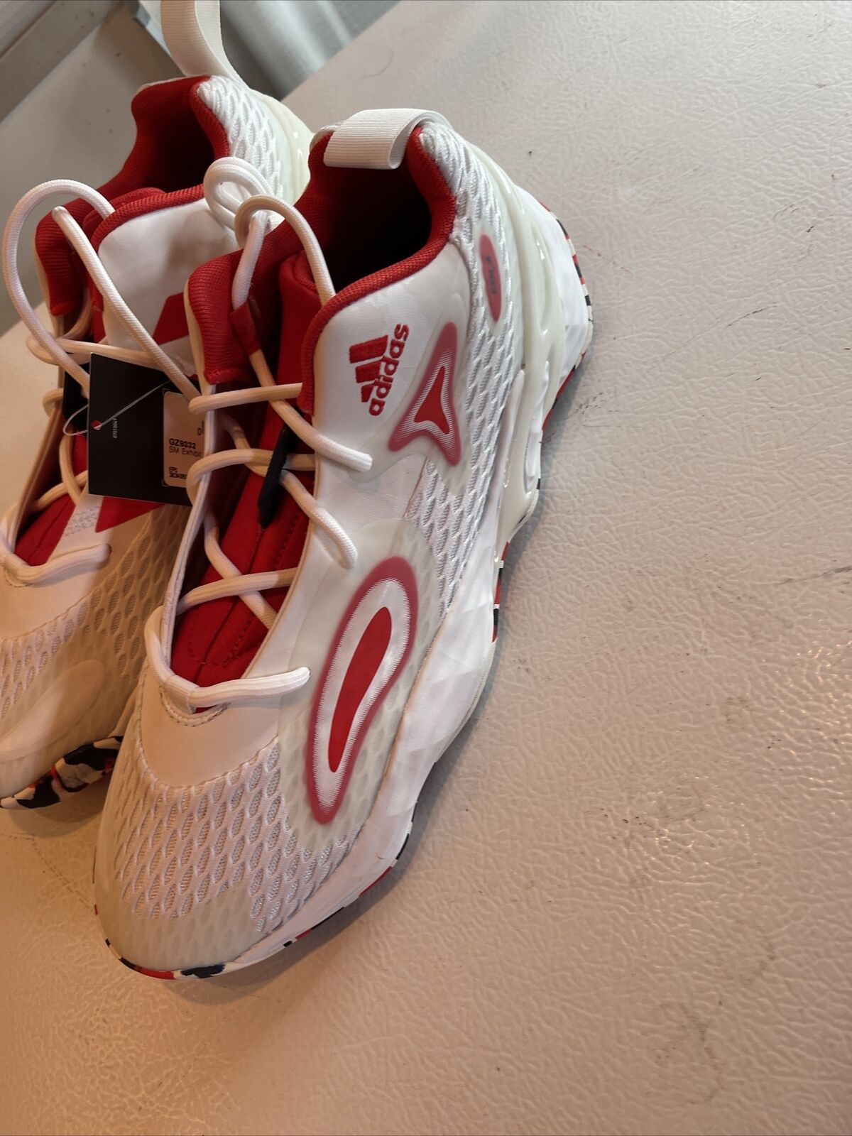 White and red Adidas SM Exhibit A Team USA sneakers with mesh design and lace-up closure