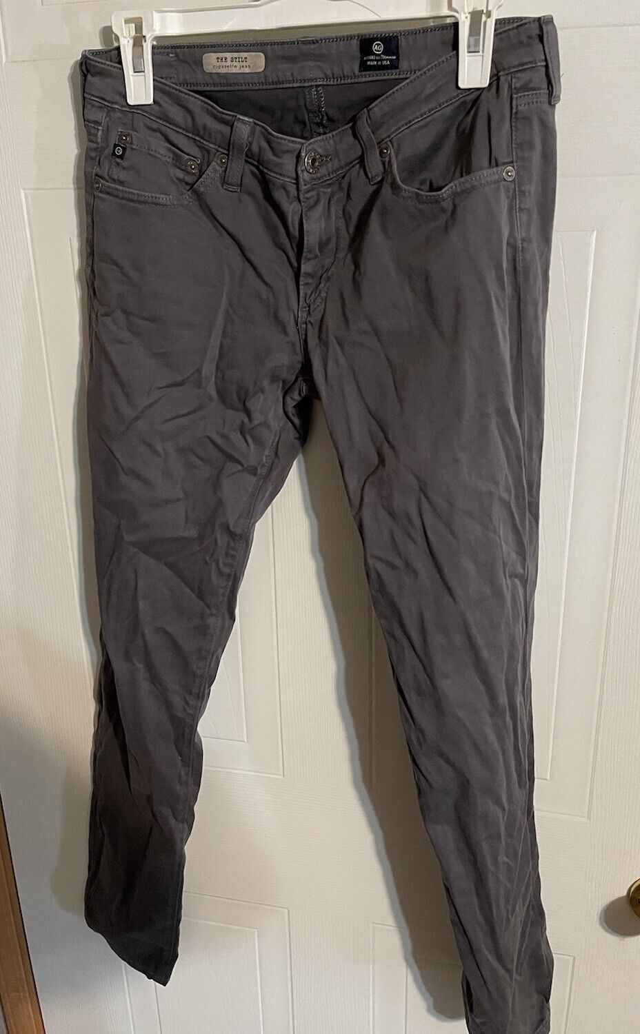 Adriano Goldschmied women's jeans in dark gray with a slim fit design hanging on a hanger