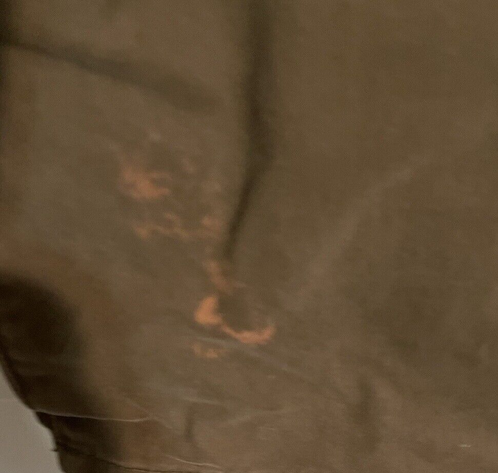 Close-up detail of brown fabric on AG The Graduate men's jeans showing texture and stitching