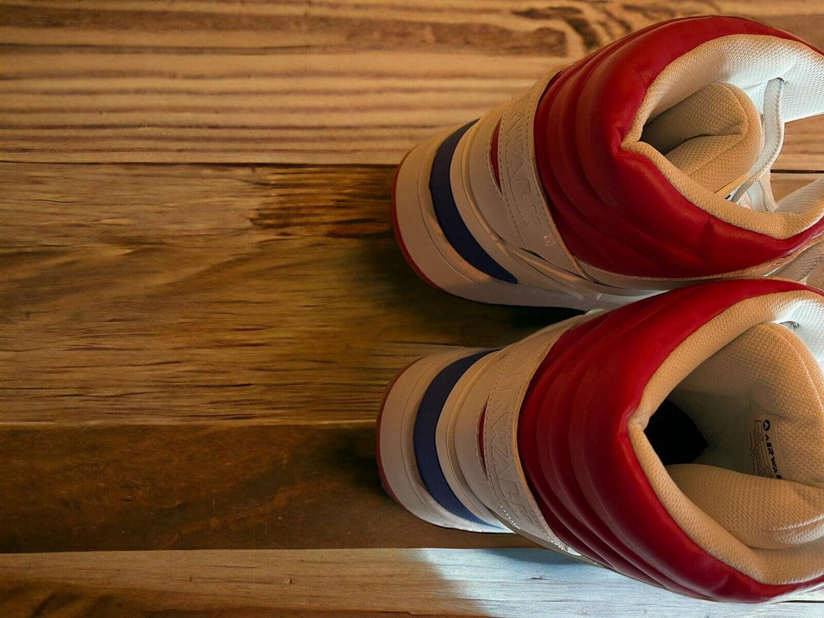 Top view of Airwalk men’s sneakers size 10.5 in white with red and blue accents on wooden floor