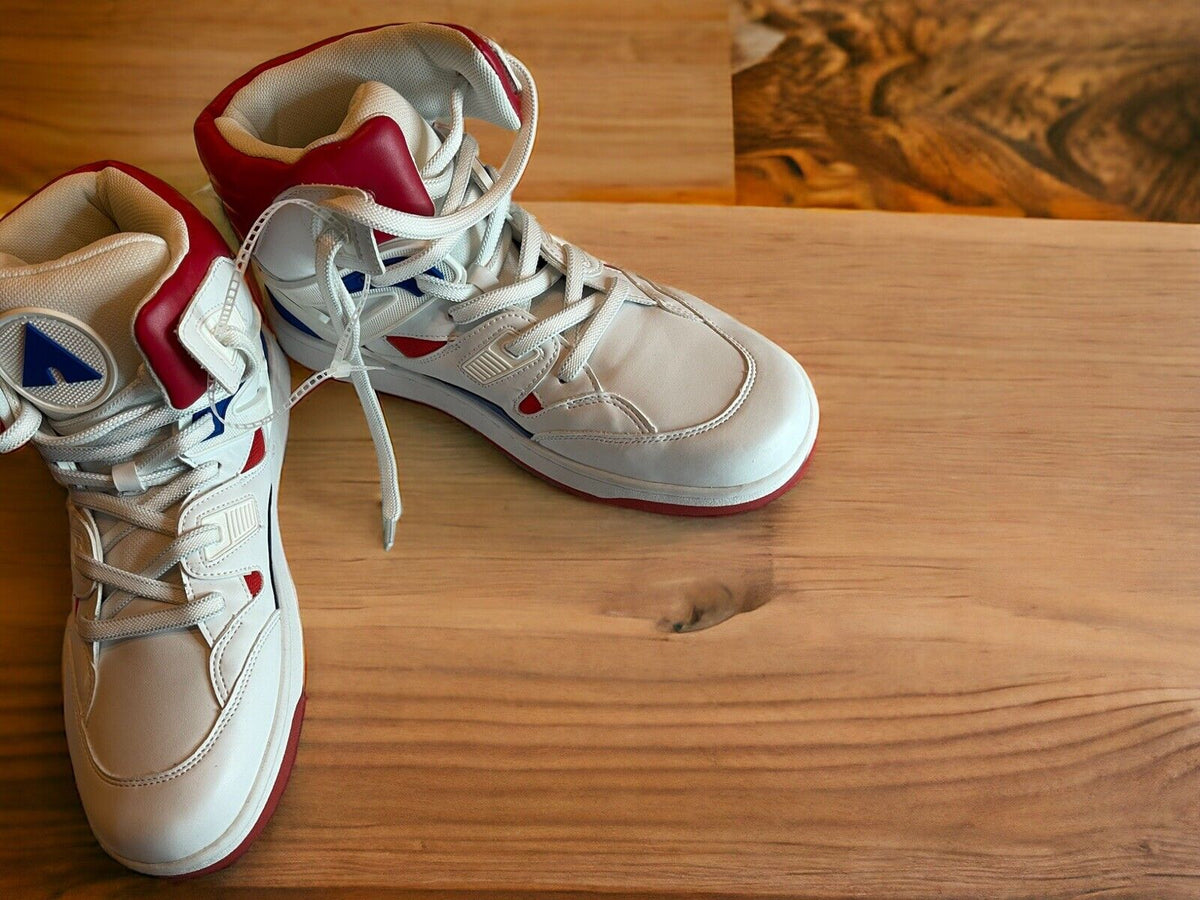 Airwalk men’s sneakers size 10.5 in white with red and blue accents on wooden surface