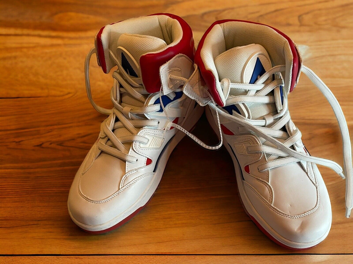 White and red Airwalk men’s sneakers size 9.5 on wooden floor with laces untied