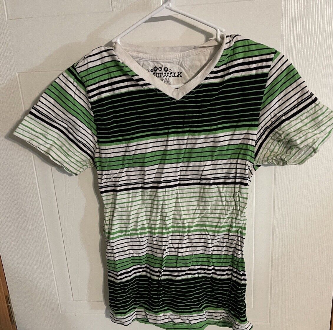 Striped Airwalk V neck T shirt in green black and white hanging on white hanger