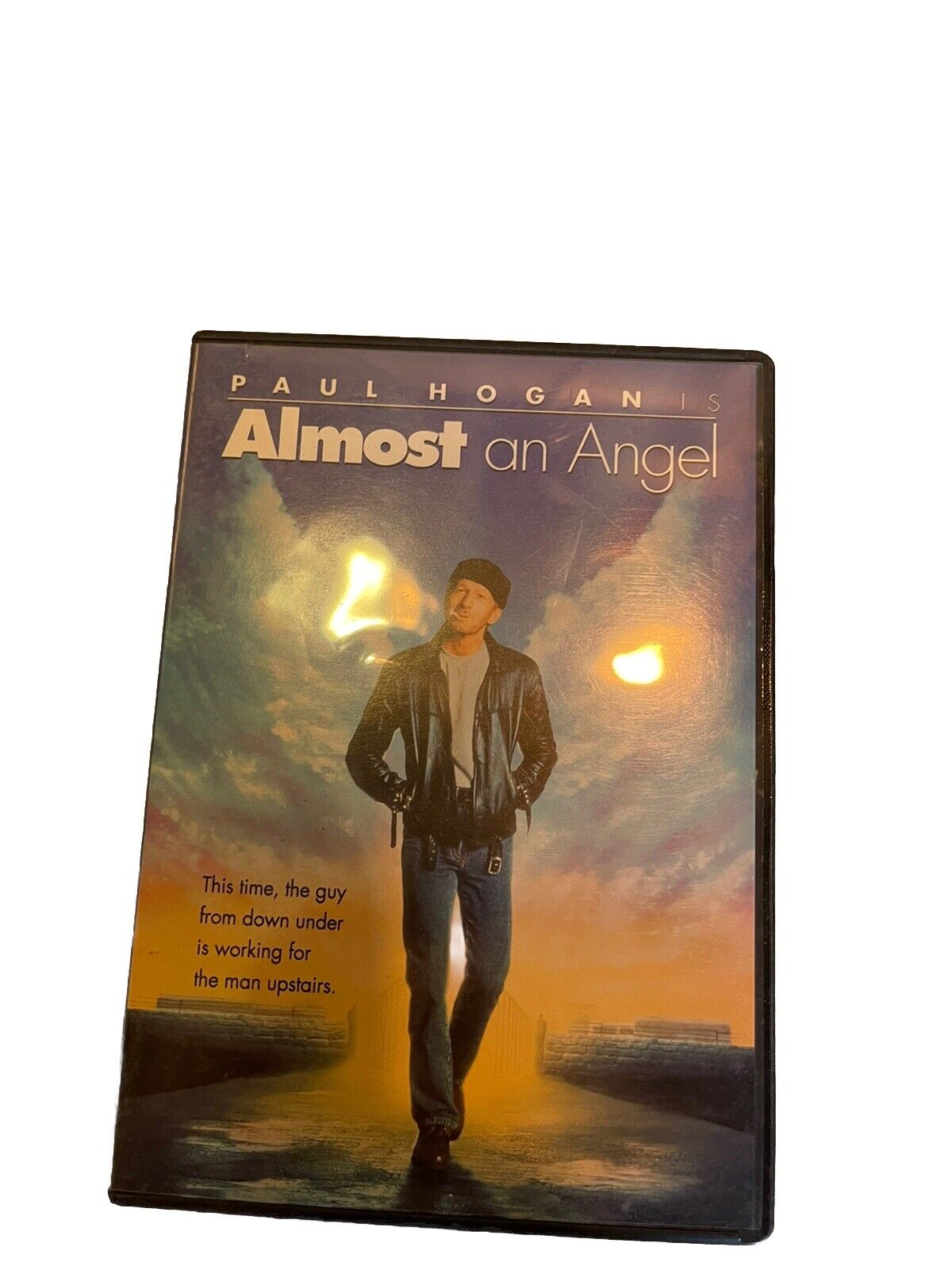 Almost an Angel DVD featuring Paul Hogan with a sunset background and tagline about a man from down under