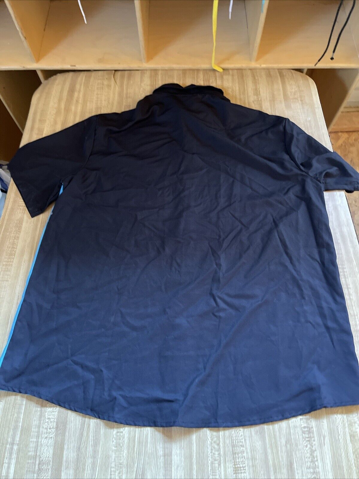 Black Aloha Hawaiian bowling shirt laid flat showing the back side with short sleeves