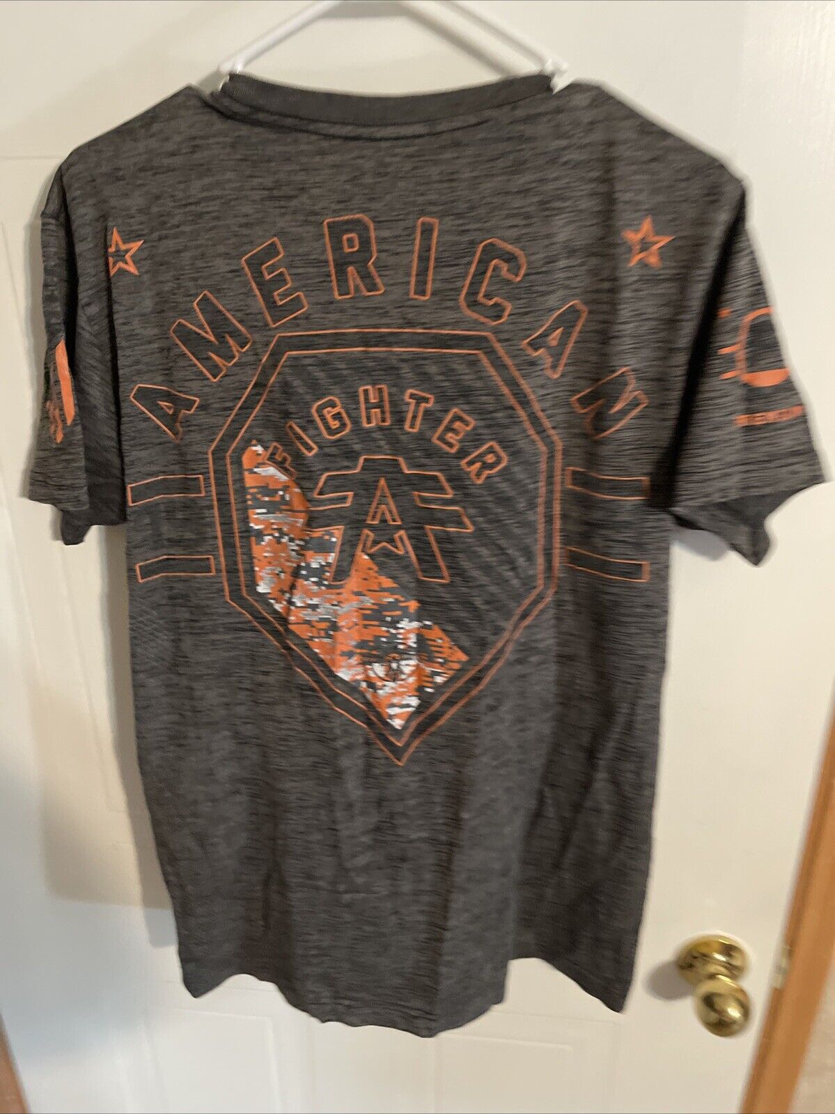 Gray American Fighter t shirt large with orange graphic design on back and sleeves
