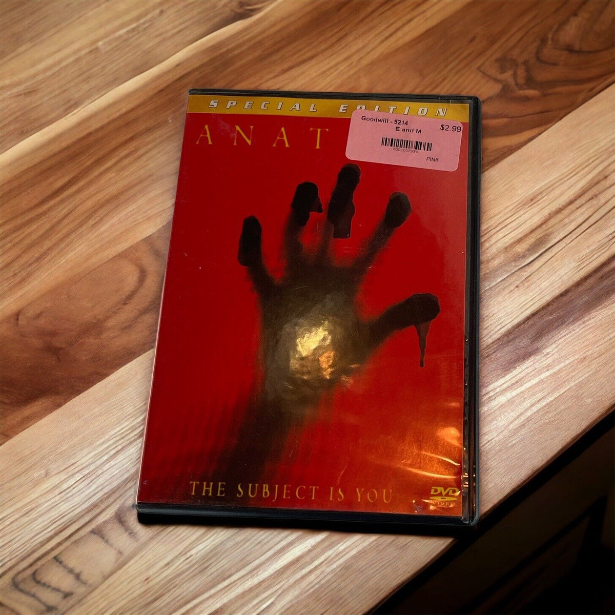 Anatomy DVD 2001 Special Edition with a red cover and a black handprint on wood surface
