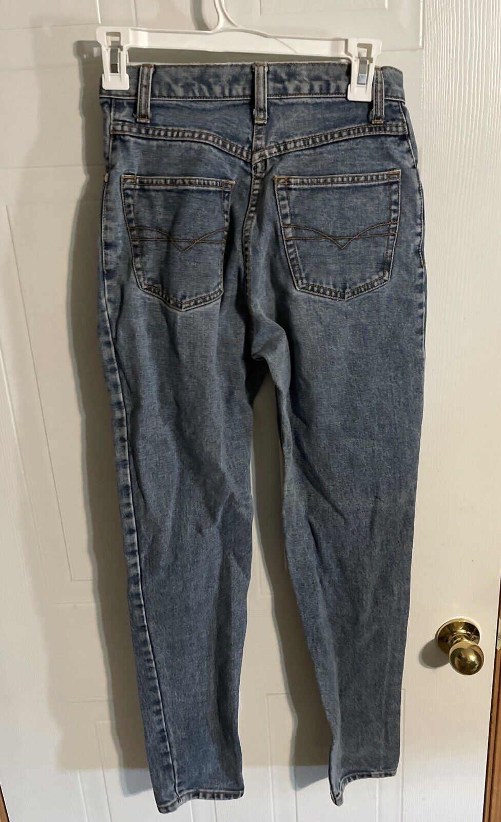 Anchor Blue relaxed fit jeans in classic blue denim hanging on a white hanger