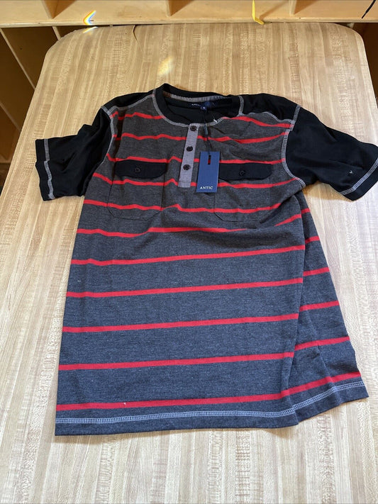 Small antic shirt for men with black and gray stripes and red accents laid flat on wooden table