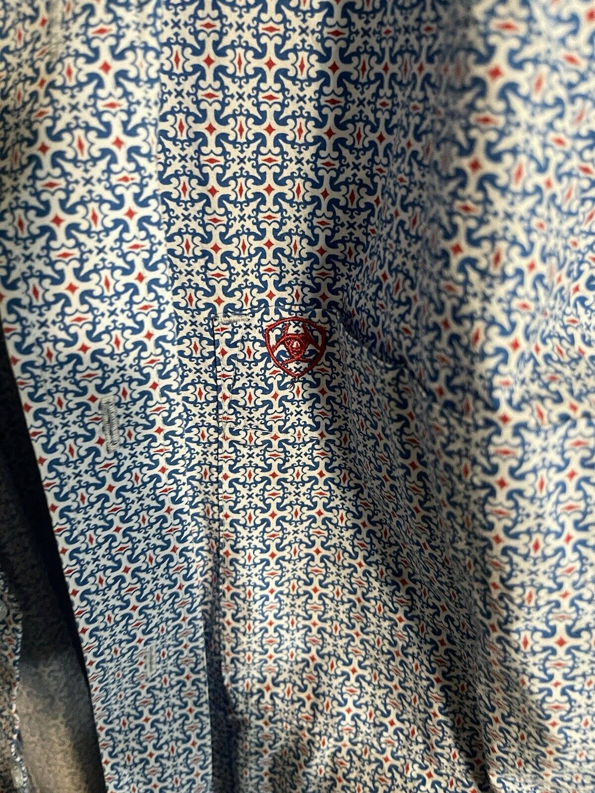Ariat men's button down shirt with intricate blue and red geometric pattern and embroidered logo
