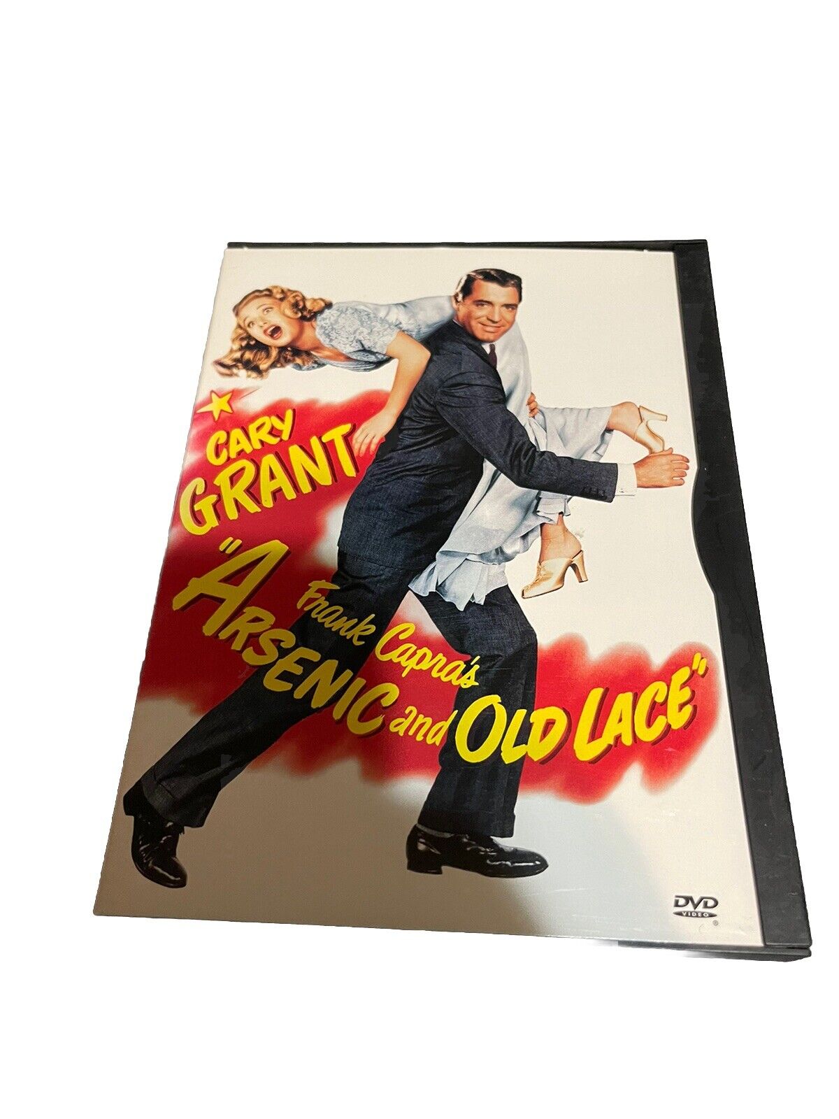 Arsenic and Old Lace DVD cover featuring Cary Grant carrying a woman with bright title text