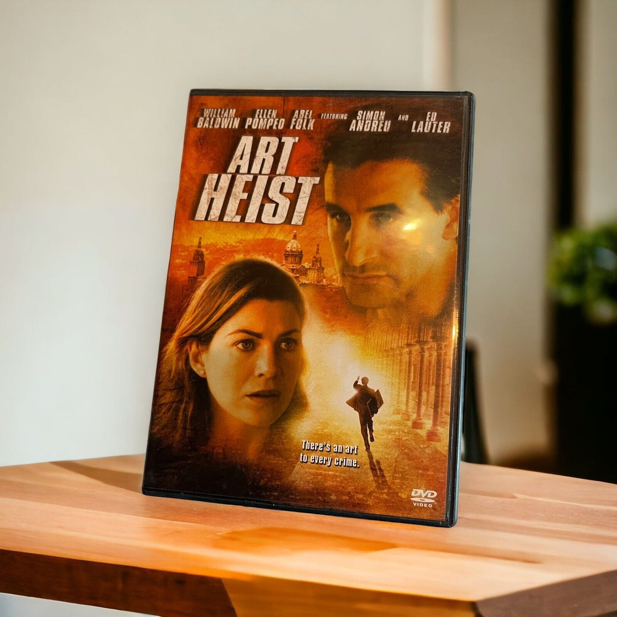 Art Heist DVD 2005 movie case featuring William Baldwin and Ellen Pompeo on a wooden surface