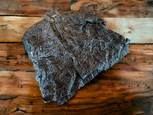 Artisan casual button down shirt with geometric pattern folded on wooden surface by 1118 Emporium