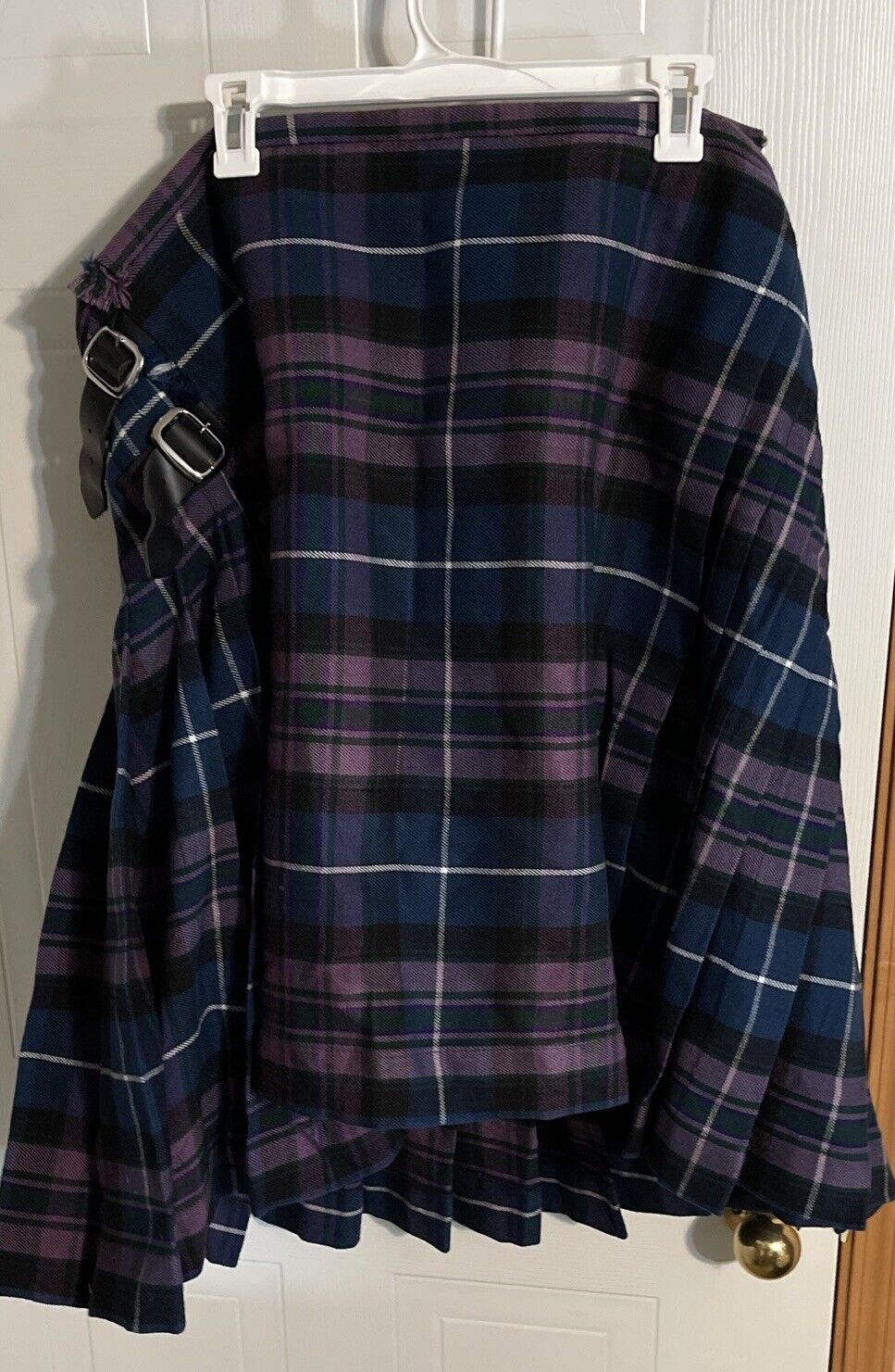 Blue and purple tartan kilt with buckles hanging on white hanger Atlanta Kilts kilt for sale