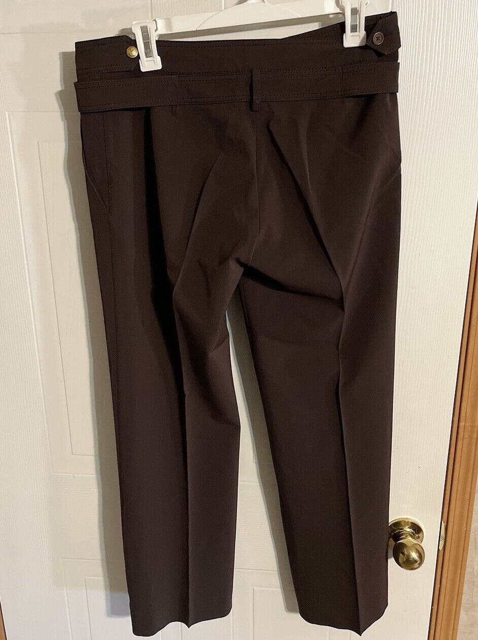 Bally women's brown dress pants hanging on white hanger showcasing tailored fit and button details