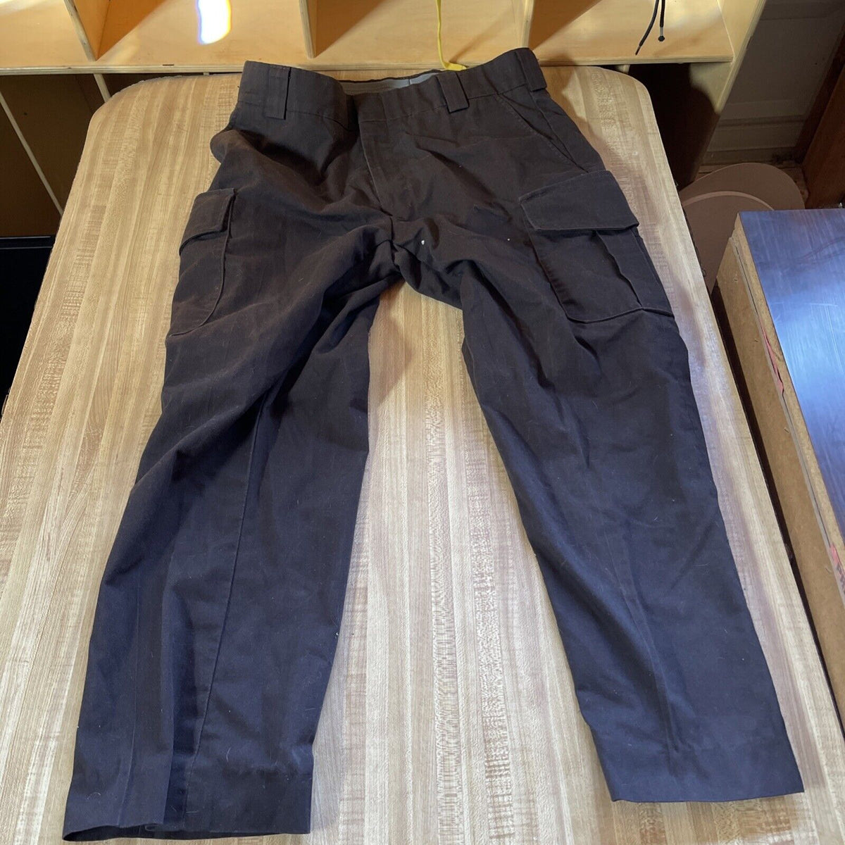 Black Blauer cargo pants 34 regular laid flat showing multiple cargo pockets and belt loops