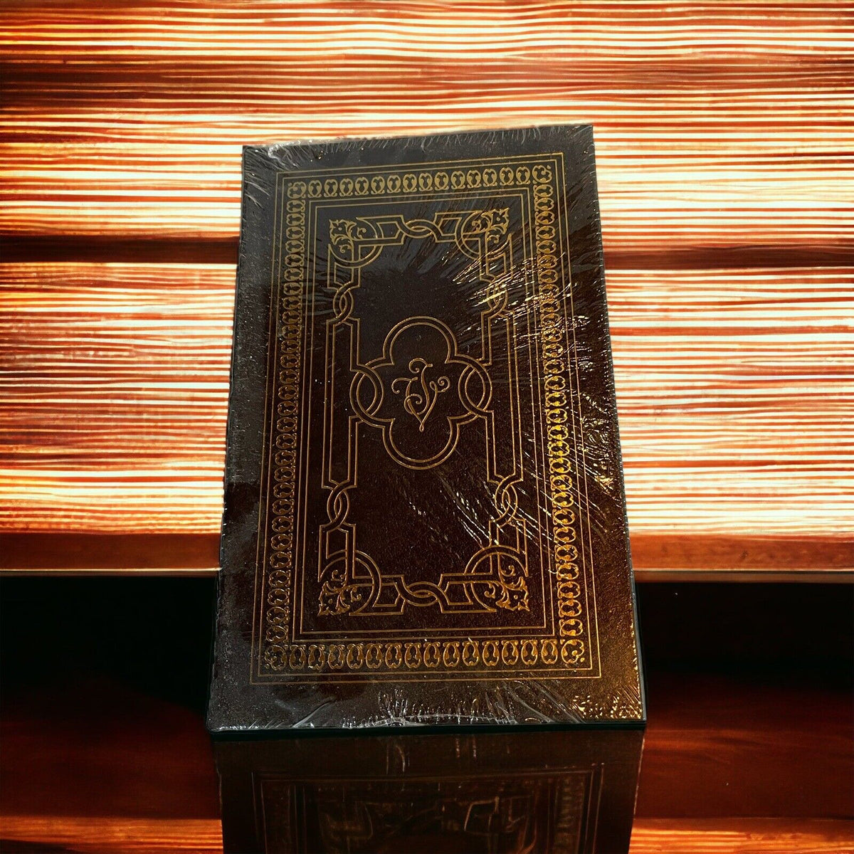 Collectible hardcover science fiction novel with ornate gold embossed black cover wrapped in plastic