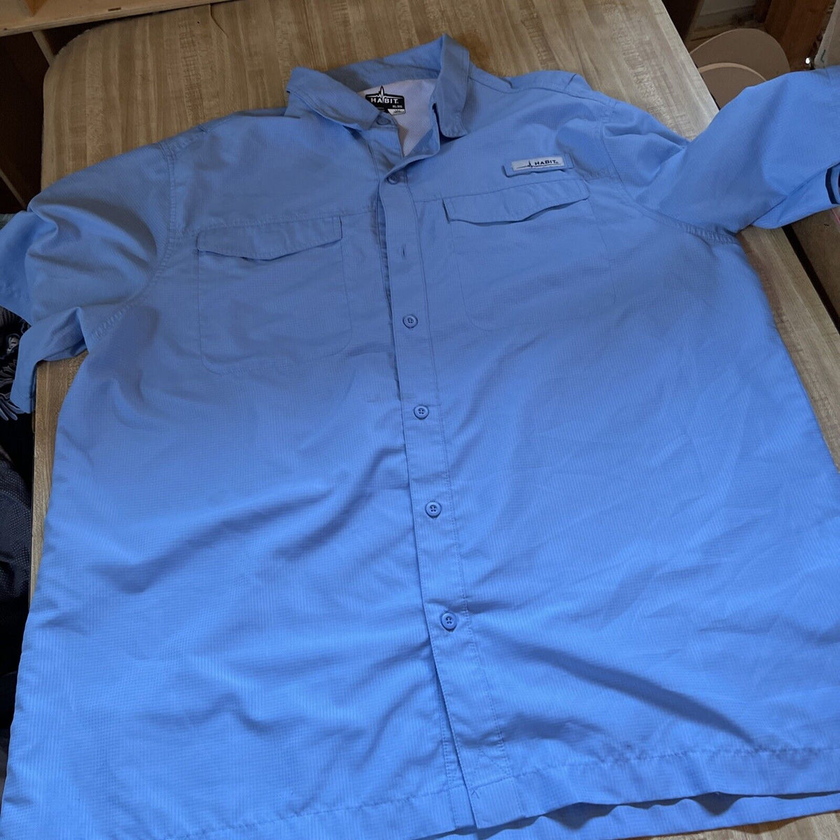 Light blue Habit vented fishing shirt XL with front pockets and button closure laid flat
