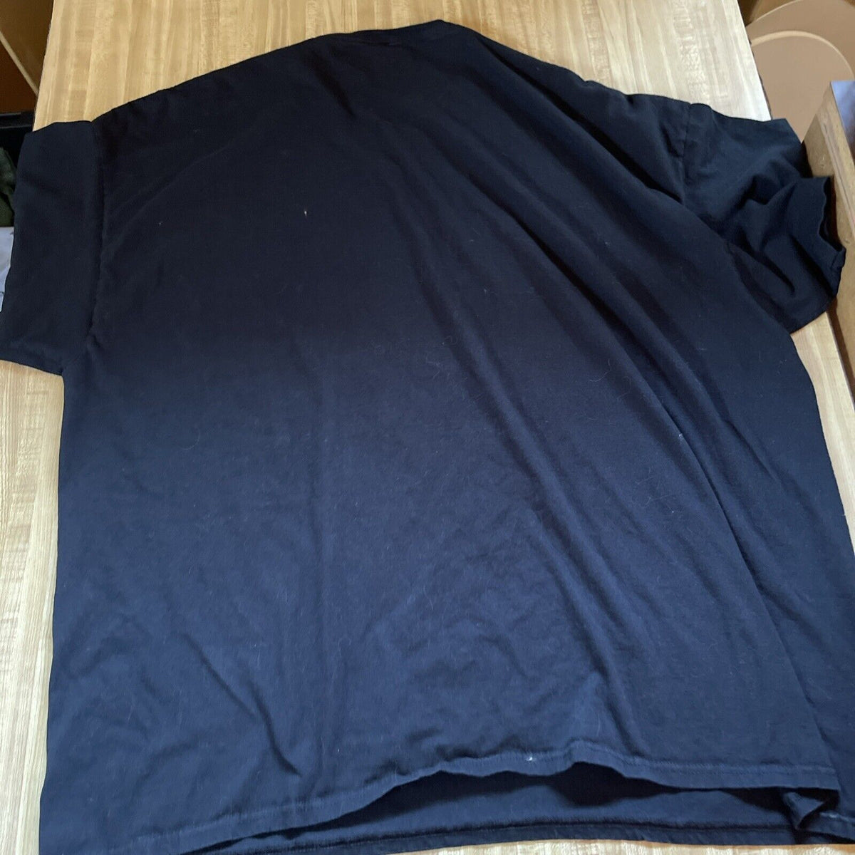 Black t-shirt laid flat featuring classic monster film apparel from 1118 Emporium