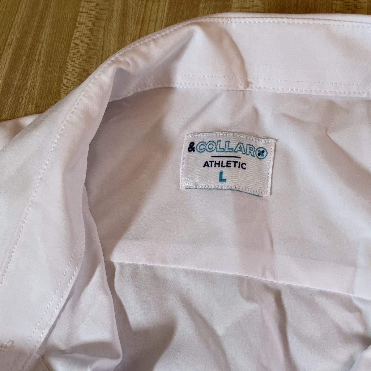 White men's athletic button up shirt from & Collar with size large label inside collar