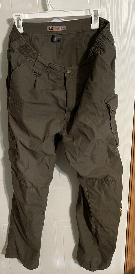 Men's tactical cargo pants in dark olive green with multiple pockets and durable fabric