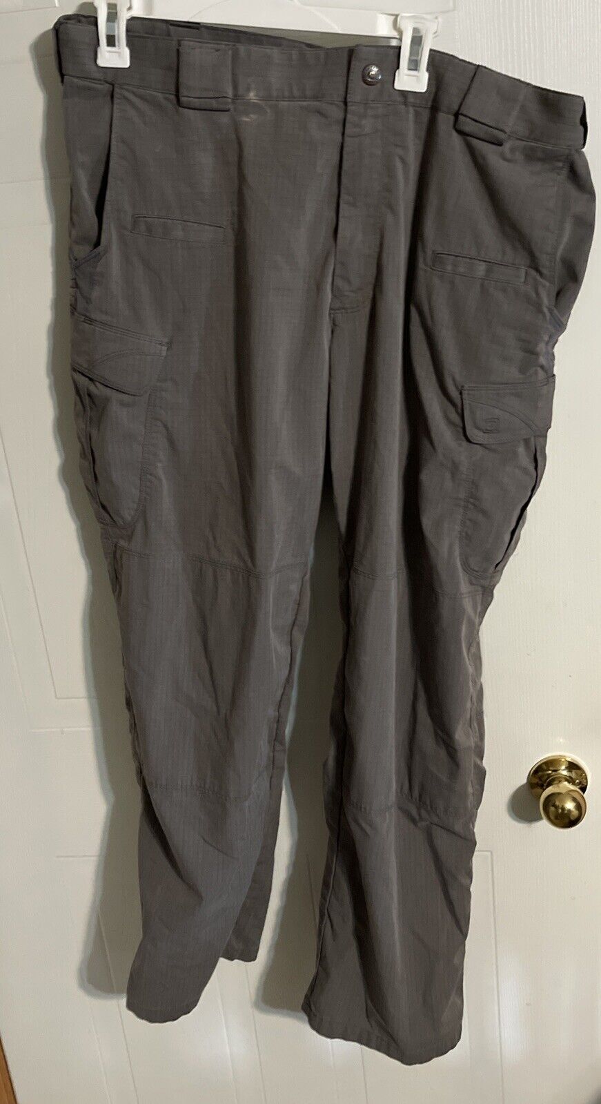 Men's tactical cargo pants in dark gray with multiple pockets ideal for outdoor and work use