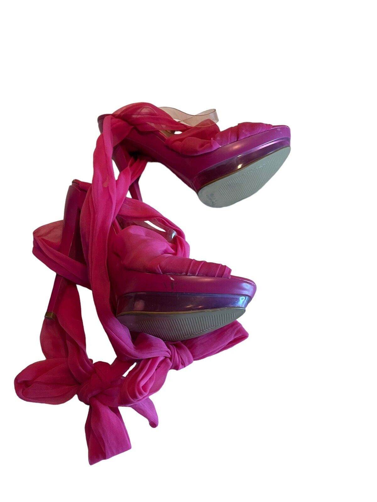 Pink strappy high heel sandals with wrap-around ankle ties and platform soles