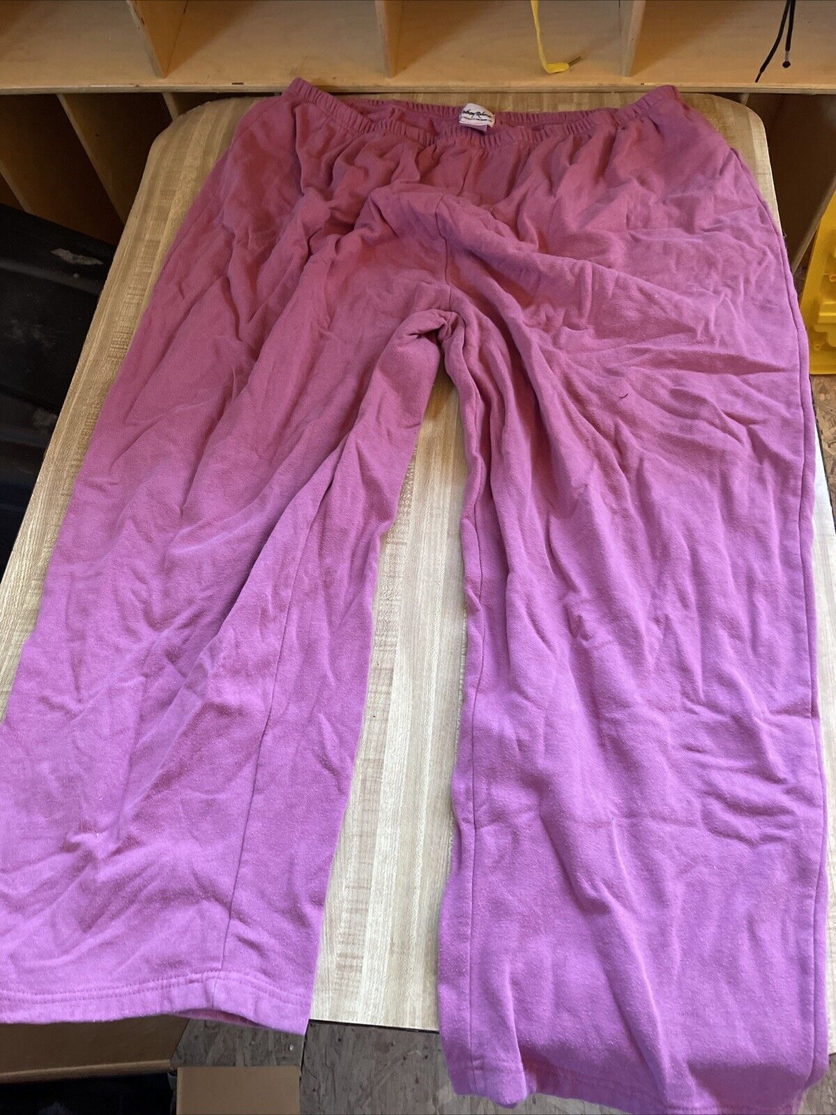 1118 Emporium plus size sweatpants 4XL in pink laid flat on a wooden surface