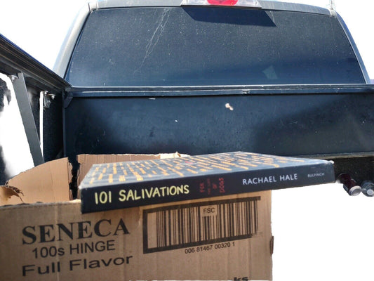 101 Salivations book by Rachael Hale placed on a cardboard box in the back of a pickup truck