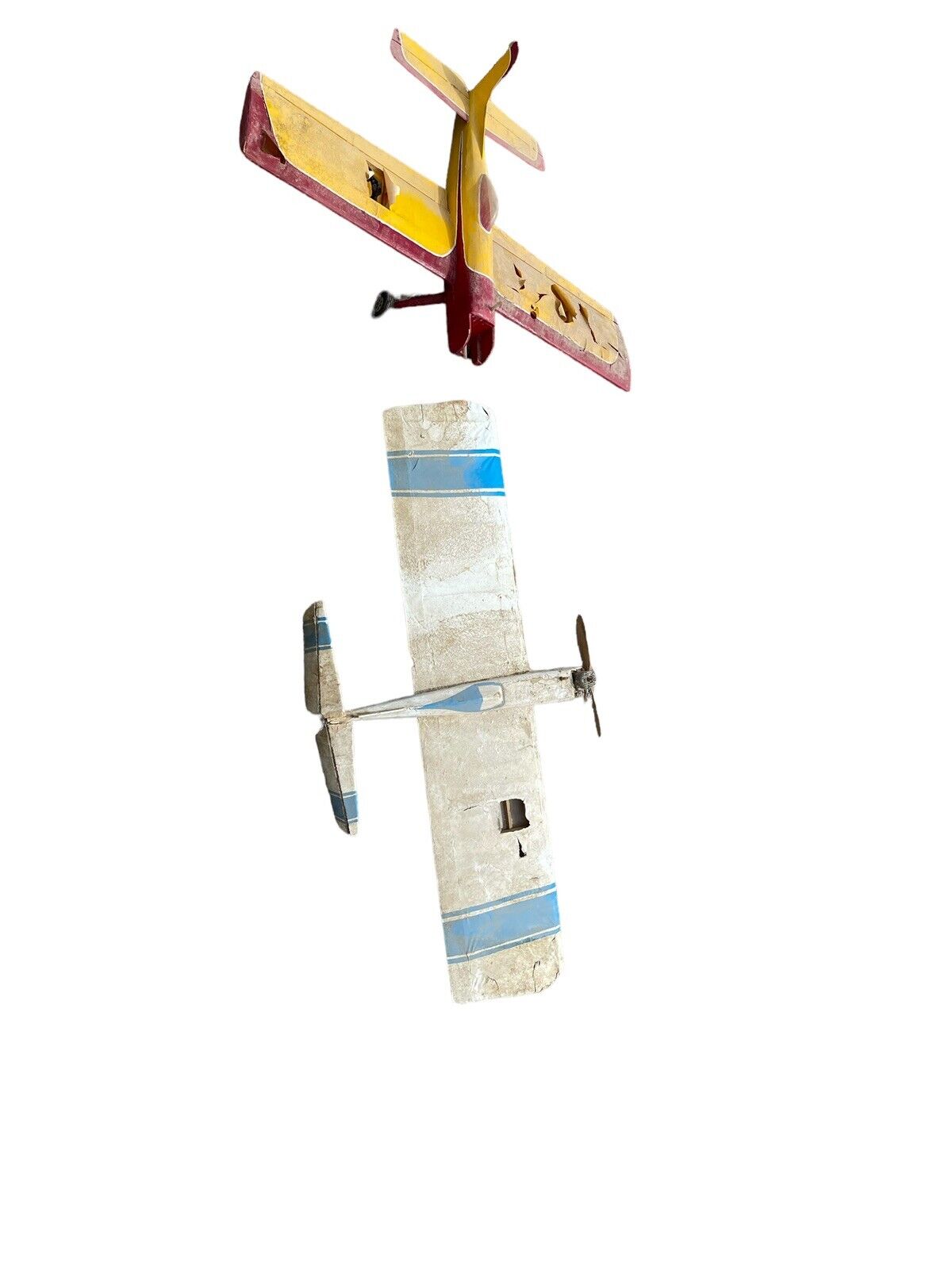 Two vintage RC airplanes for parts with worn paint and propellers isolated on white background