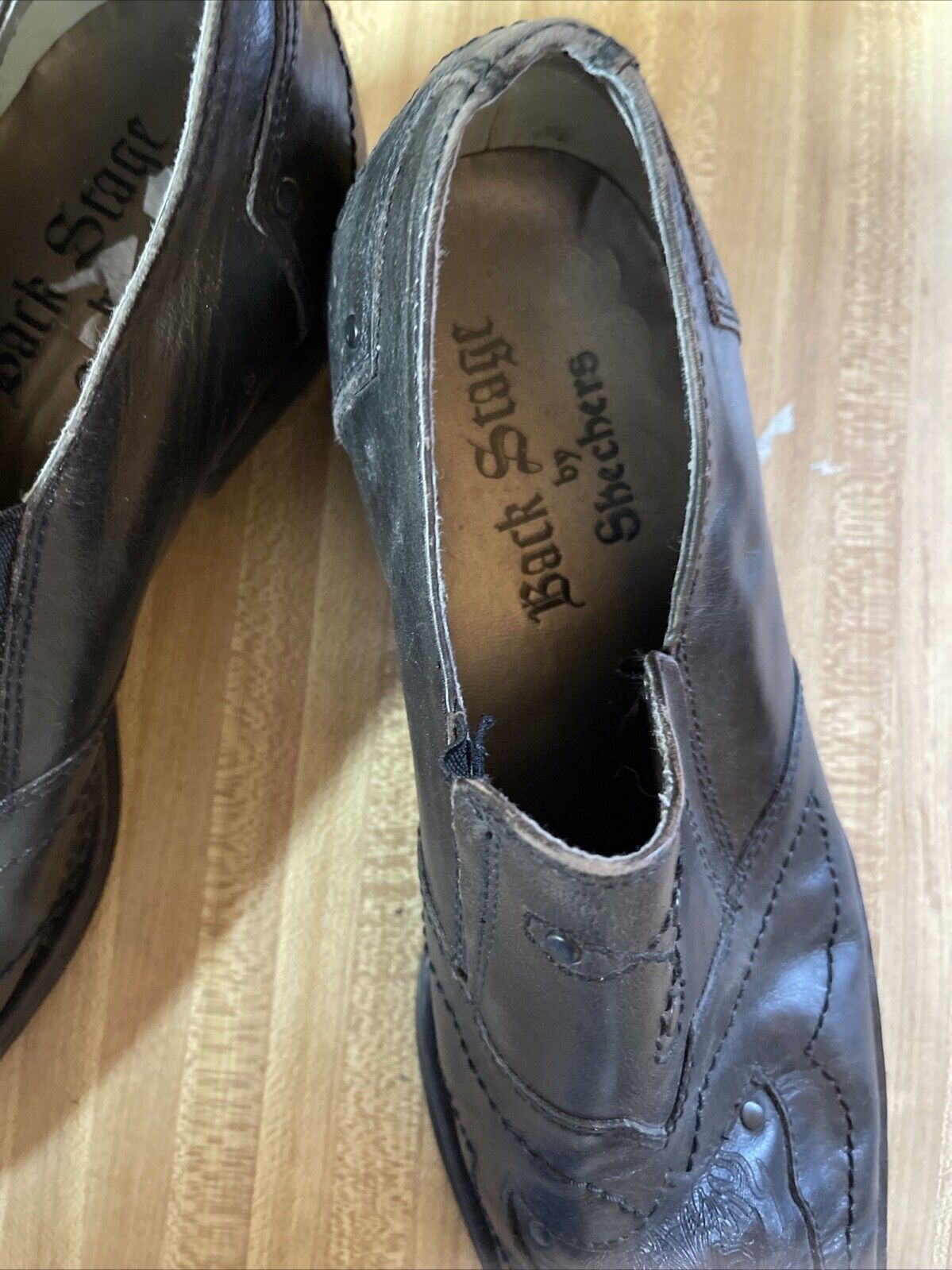 Black leather Back Stage by Skechers shoes with stitched detailing and slip-on design