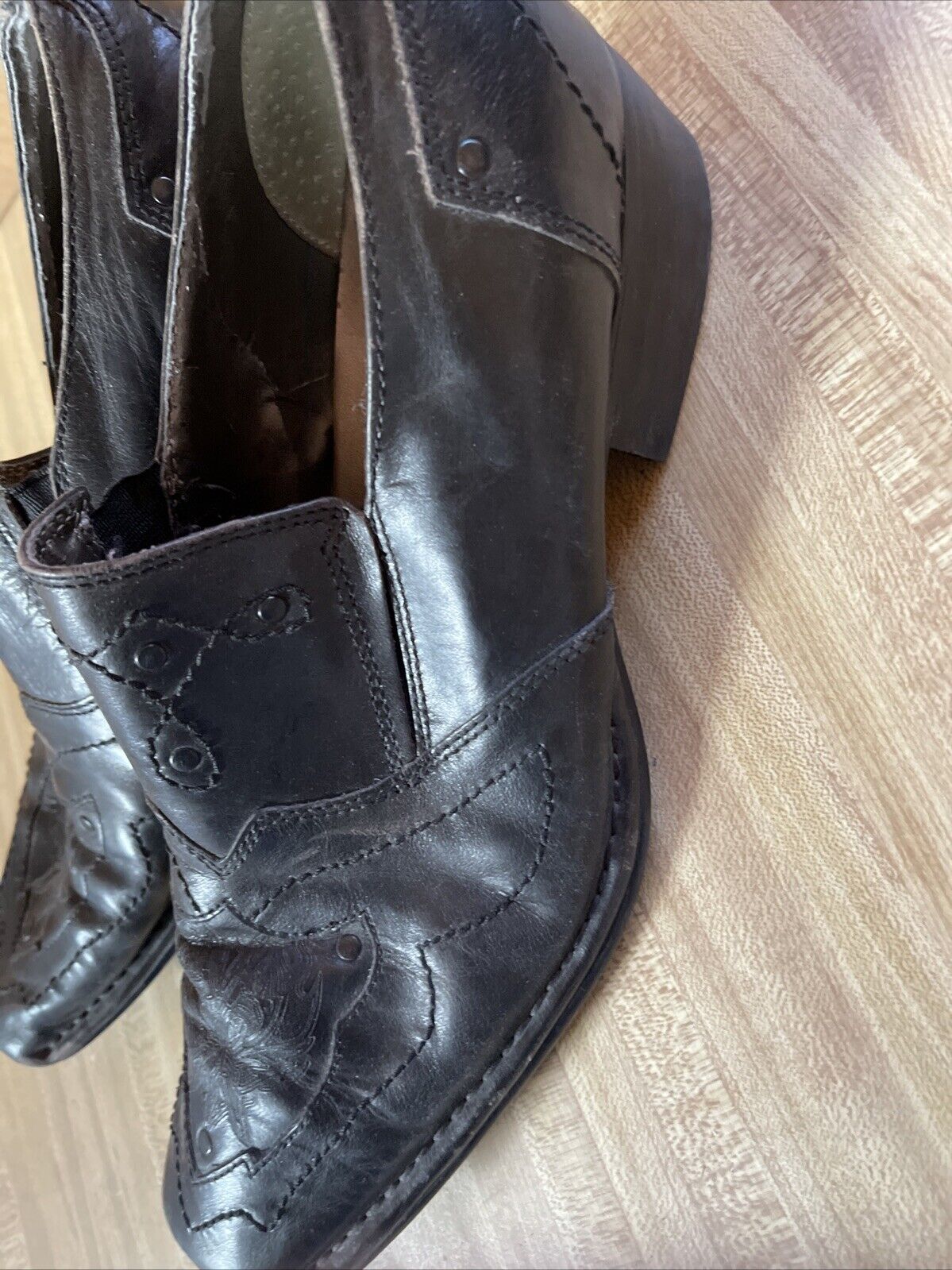 Black leather Back Stage by Skechers shoes with stitched detailing and stacked heel on wooden floor